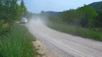 Vozila dvigujejo prah, ki nato prekrije poljščine, trte in sadno drevje.