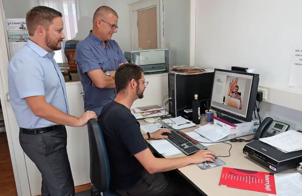 Tehnik Denis Scher direktorju in odgovornemu uredniku Primorskih novic Roku Hladniku in Antiši Korljanu kaže izdajo pred 
pošiljanjem v tiskarno.