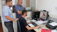 Tehnik Denis Scher direktorju in odgovornemu uredniku Primorskih novic Roku Hladniku in Antiši Korljanu kaže izdajo pred 
pošiljanjem v tiskarno.