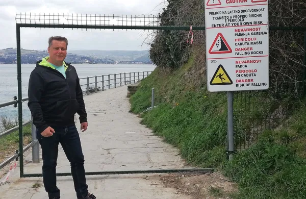 Egon Štibilj, poveljnik piranske CZ, pred ograjo, ki je preprečevala dostop do poti pod klifom, dokler neznanci žic niso preščipnili. 