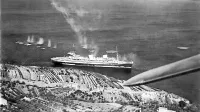 Napad na Rexa. V letih  1933-1935 se je  ponašal z modrim trakom 
za najhitrejše prečkanje Atlantika proti zahodu. Zgradili so ga v   
dveh letih in petih mesecih, krstila  sta ga  italijanska kraljica Elena 
in kralj Viktor Emanuel III. 