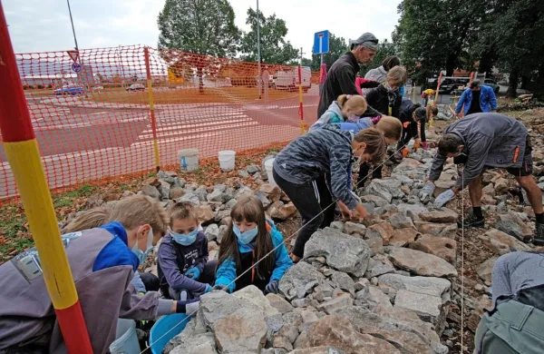  Mali zidarji so se delu posvetili na krožišču pri Divači, kjer bodo vozniki lahko občudovali tipični kraški zid. 