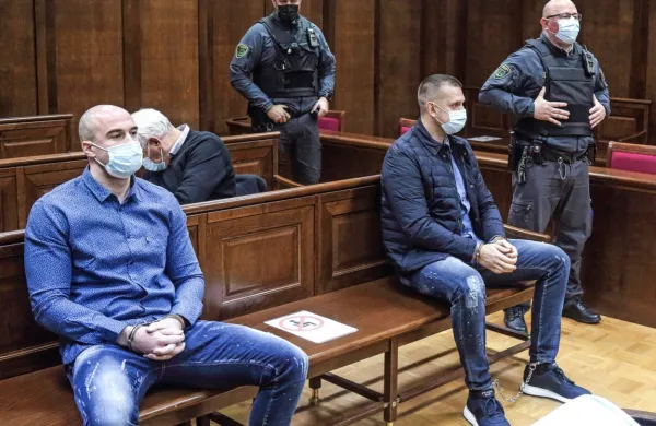 Bojan Stanojević (levo) in  Klemen  Kadivec  (desno, ob njem  
pravosodna policista) sta v priporu  od  novembra 2019,  ko so  ju 
policisti prijeli v Ankaranu.