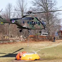 Helikopterja  vodo za gašenje zajemata v bazenu, ki so ga gasilci 
postavili na vzletišču na Kovku.