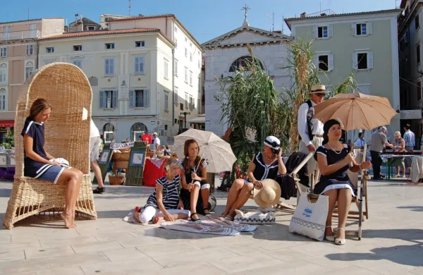 Društvo Anbot ohranja kulturno dediščino tudi tako, da Tartinijev 
trg spremeni v plažo in se obleče v kopalke “kot anbot”. 