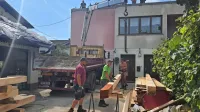 Ena ekipa barva, druga pripravlja grede, tretja postavlja.