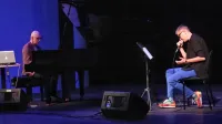 Sinoči se je v Pulju predstavila tudi  slovenska pesnica  Anja Zag Golob, ki je na performansu Šesto čulo nastopila 
s skladateljem Dragom Ivanušo (na fotografiji z nastopa v Kopru leta 2021) in ilustratorjem Danijelom Žežljem.