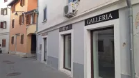 Občinski poslovni prostor v Alietovi ulici spet izpraznjen sameva. 
Da je v njem še do nedavnega vse vrvelo od umetnosti, priča le 
napis Galerija ... 