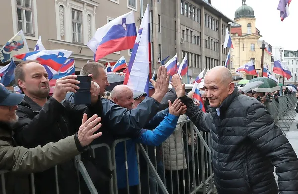 Janez Janša v slogu športnega zvezdnika med svojimi podporniki 
pred sodiščem v Celju. 