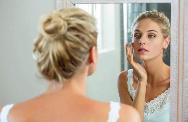 Reflection of woman checking her skin in bathroom mirror,Image: 280784825, License: Royalty-free, Restrictions:, Model Release: yes, Credit line: -/Wavebreak/Profimedia