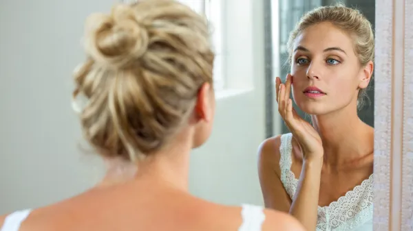 Reflection of woman checking her skin in bathroom mirror,Image: 280784825, License: Royalty-free, Restrictions:, Model Release: yes, Credit line: -/Wavebreak/Profimedia