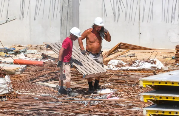 Koper, 18.07.2023GradbiĂ&para;ca, gradbena dela, delavci vrocina, poletje, delovni pogojigradbiĂ&para;ce Dolinska cesta, gradnja neprofitnih stanovanj
