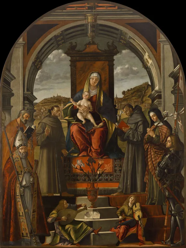 V osrednjem prizoru je upodobljena Marija z detetom na prestolu postavljena pod polkrožni renesančni obok, ob njej pa so postavljeni po trije svetniki na vsaki strani. 