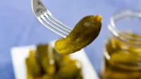 Green pickled cucumber impaled with fork. Marinated appetizer.,Image: 1021324489, License: Royalty-free, Restrictions:, Model Release: no, Credit line: Iakov Filimonov/Alamy/Profimedia