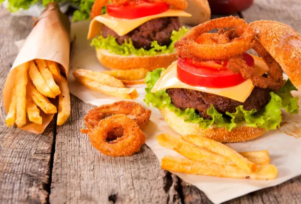 Onion rings,french fries and cheeseburger on the wooden table,Image: 316979688, License: Royalty-free, Restrictions:, Model Release: no, Credit line: badmanproduction, YAY Media AS/Alamy/Profimedia
