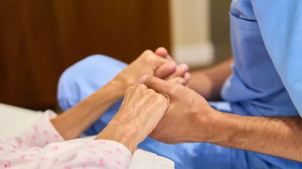 A healthcare worker holds an elderly patient's hands, providing comfort and care at a senior rehabilitation center. An image symbolizing support, compassion, and professional healthcare for senior members.,Image: 962765063, License: Royalty-free, Restrictions:, Model Release: yes, Credit line: Robert Kneschke/Alamy/Profimedia