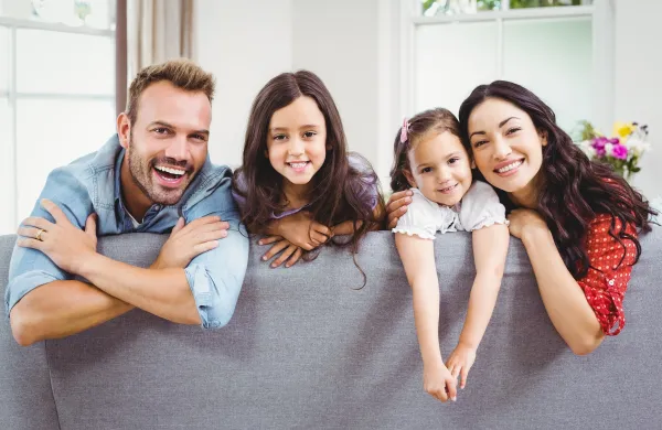 Happy family relaxing while leaning on sofa at home,Image: 280543716, License: Royalty-free, Restrictions:, Model Release: yes