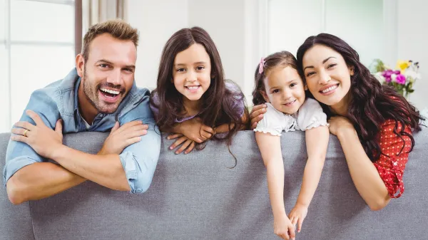 Happy family relaxing while leaning on sofa at home,Image: 280543716, License: Royalty-free, Restrictions:, Model Release: yes