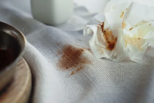 Chocolate stain on white fabric with a crumpled napkin nearby.,Image: 993759981, License: Royalty-free, Restrictions:, Model Release: no, Credit line: towfiqu Barbhuiya/Alamy/Profimedia