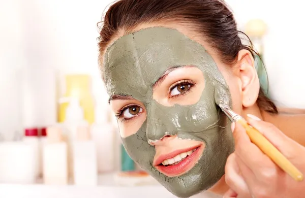 Happy woman with clay facial mask in beauty spa.,Image: 159847935, License: Royalty-free, Restrictions:, Model Release: yes, Credit line: Gennadiy Poznyakov/Alamy/Profimedia