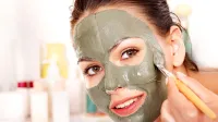 Happy woman with clay facial mask in beauty spa.,Image: 159847935, License: Royalty-free, Restrictions:, Model Release: yes, Credit line: Gennadiy Poznyakov/Alamy/Profimedia
