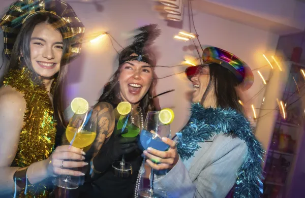 Diverse women in festive party hats and tinsel clink colorful lime garnished cocktails, laughing and dancing at a vibrant, energetic new years eve or costume party celebration,Image: 1060503542, License: Rights-managed, Restrictions:, Model Release: yes, Credit line: Unai Huizi/imageBROKER/Profimedia