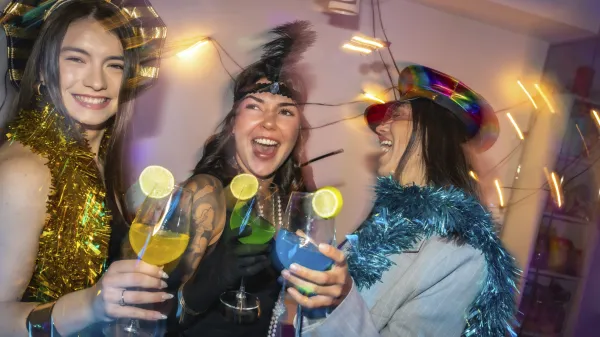 Diverse women in festive party hats and tinsel clink colorful lime garnished cocktails, laughing and dancing at a vibrant, energetic new years eve or costume party celebration,Image: 1060503542, License: Rights-managed, Restrictions:, Model Release: yes, Credit line: Unai Huizi/imageBROKER/Profimedia
