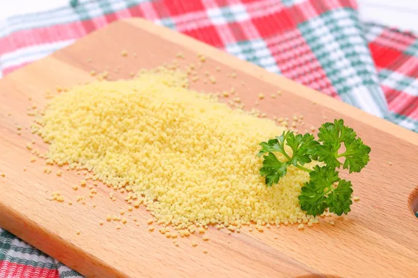 pile of raw couscous on wooden cutting board - close up,Image: 354011504, License: Rights-managed, Restrictions:, Model Release: no, Credit line: -/Digifoodstock/Profimedia