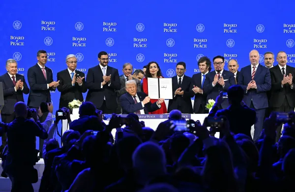 Paraguay's President Santiago Pena (2L), Kazakh President Kassym-Jomart Tokayev (3L), Bahrein's Minister of the Prime Minister's court Sheikh Isa bin Salman bin Hamad al-Khalifa (4L), Pakistan's Prime Minister Shehbaz Sharif (5L), Kosovo's President Vjosa Osmani (C-R), Morocco's Foreign Minister Nasser Bourita (7R), Argentina's President Javier Milei (6R), Mongolia's Prime minister Gombojav Zandanshatar (5R), Armenia's Prime Minister Nikol Pashinyan (4R), Bulgaria's former Prime Minister Rosen Zhelyazkov (3R), Turkey's Foreign Minister Hakan Fidan (2R) and Azerbaijan's President Ilham Aliyev pose with US President Donald Trump (C) holding a signed founding charter at the "Board of Peace" meeting during the World Economic Forum (WEF) annual meeting in Davos on January 22, 2026. US President Donald Trump will show off his new "Board of Peace" at Davos on January 22, 2026 burnishing his claim to be a peacemaker a day after backing off his own threats against Greenland. Originally meant to oversee the rebuilding of Gaza after the war between Hamas and Israel, the board's charter does not limit its role to the Strip, and has sparked concerns that Trump wants it to rival the United Nations.,Image: 1068269690, License: Rights-managed, Restrictions:, Model Release: no, Credit line: Fabrice COFFRINI/AFP/Profimedia