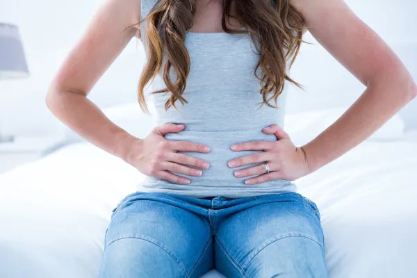 Brunette suffering from stomach pain at home in the bedroom,Image: 244457722, License: Royalty-free, Restrictions:, Model Release: yes, Credit line: -/Wavebreak/Profimedia