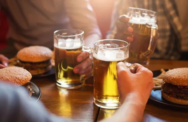 Men drinking light beer and eating burgers in pab,Image: 1007712974, License: Royalty-free, Restrictions:, Model Release: no, Credit line: Prostock-studio/Alamy/Profimedia