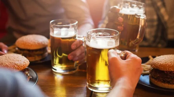 Men drinking light beer and eating burgers in pab,Image: 1007712974, License: Royalty-free, Restrictions:, Model Release: no, Credit line: Prostock-studio/Alamy/Profimedia