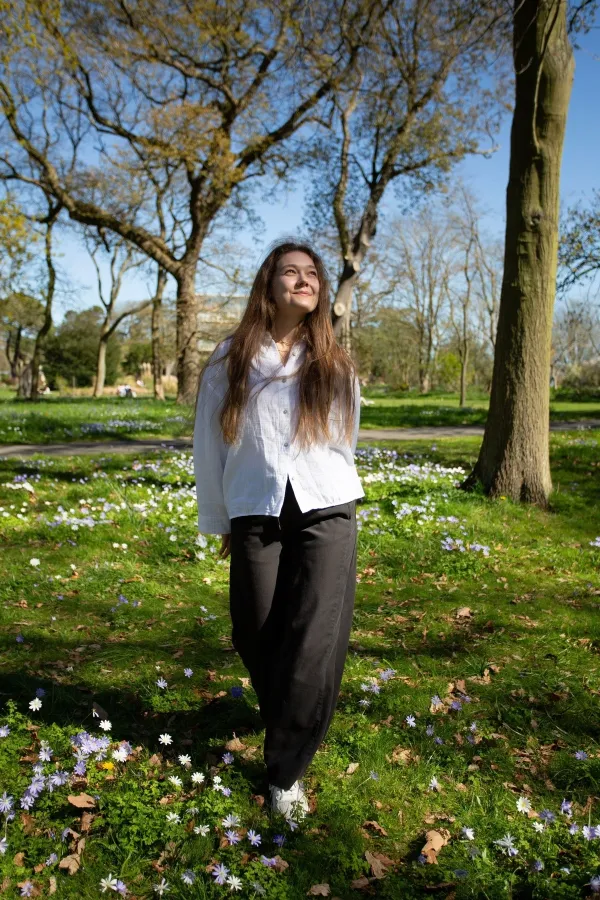 A woman is thoroughly enjoying a beautiful, sunny spring day surrounded by blooming flowers and lush greenery,Image: 1024420215, License: Royalty-free, Restrictions:, Model Release: no, Credit line: Maryna Nazina/Alamy/Profimedia