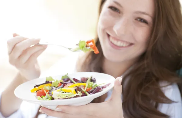 MODEL RELEASED. Young woman eating a salad.,Image: 181883208, License: Royalty-free, Restrictions:, Model Release: yes, Credit line: IAN HOOTON/Sciencephoto/Profimedia