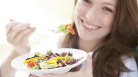 MODEL RELEASED. Young woman eating a salad.,Image: 181883208, License: Royalty-free, Restrictions:, Model Release: yes, Credit line: IAN HOOTON/Sciencephoto/Profimedia