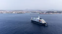 This aerial picture shows a general view of the cruise ship MV Hondius stationary off the port of Praia, the capital of Cape Verde, on May 5, 2026. The WHO said on May 5, 2026 that Spain would "welcome" a cruise ship anchored off Cape Verde with suspected hantavirus cases onboard, enabling a probe and assessment of the risk to the remaining passengers. WHO epidemic and pandemic preparedness and prevention director Maria Van Kerkhove told reporters the ship would head for the Canary islands.,Image: 1096675323, License: Rights-managed, Restrictions:, Model Release: no, Credit line: AFP/AFP/Profimedia