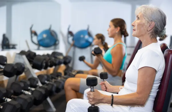 Mature sportswoman doing exercises with a barbell and dumbbells in the gym,Image: 1008286997, License: Royalty-free, Restrictions:, Model Release: no, Credit line: Iakov Filimonov/Alamy/Profimedia
